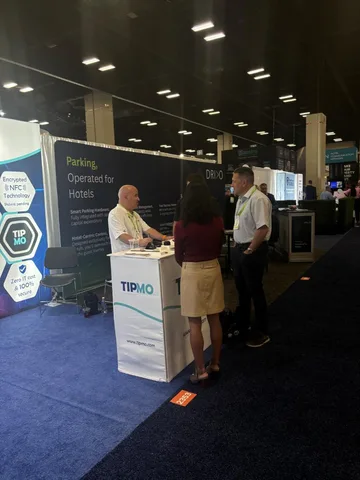 Hospitality professionals visiting the TIPMO booth at HITEC to learn about NFC tipping and hotel-centric solutions