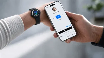 Guest holding a phone with the TIPMO tipping page open, sending a $10 tip to a worker wearing a TIPMO NFC wristband