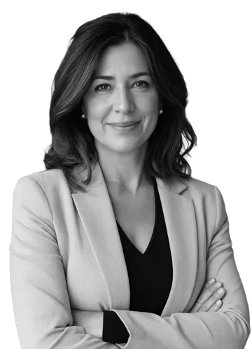 Black-and-white portrait of a smiling woman in a light blazer with her arms crossed